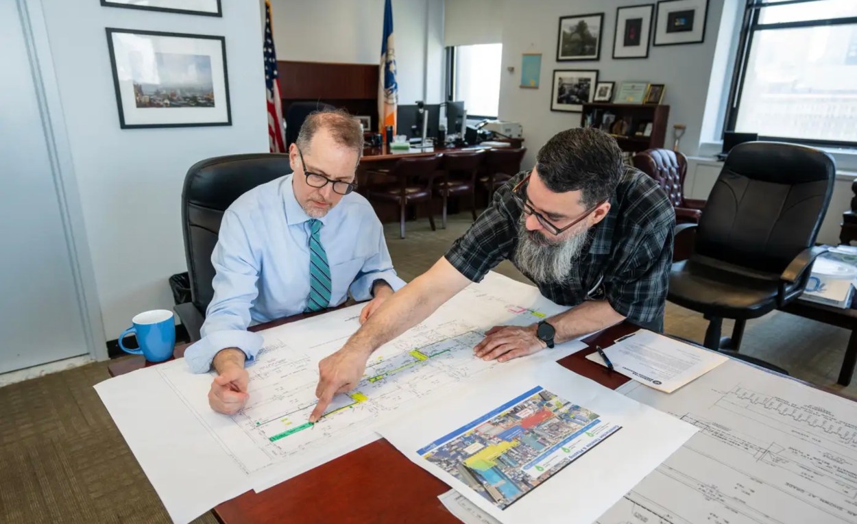 Hector Rivera, pictured with Manhattan Borough President Mark Levine (seated),
over sees the boroughs changing topography.
Reuben Torres / Manhattan borough president's office