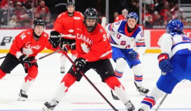 Canada's Gavin McKenna (9) skates with the puck as United States' Drew Fortescue (5) defends during the second period of an IIHF World Junior Hockey Championship tournament game in Ottawa, Ontario, Dec. 31, 2024.
