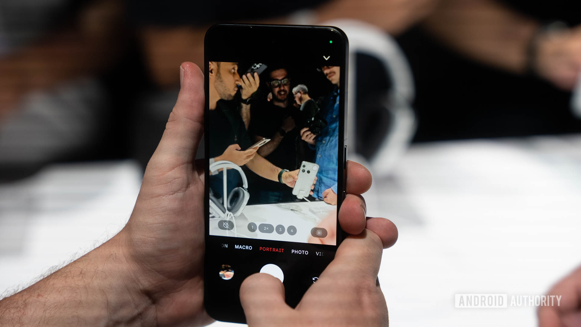 Nothing Phone 3 in hand showing camera interface with Portrait mode highlighted