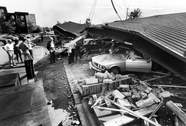 Cars are covered with a roof and other rubble after violent winds tore the top off a Northbrook garage on July 5, 1980. (Walter Kale/Chicago Tribune)