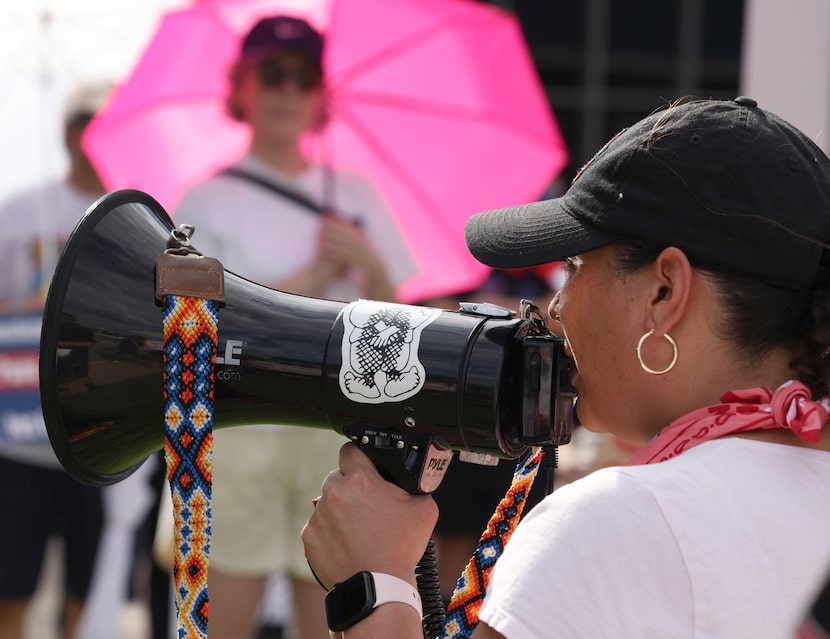 Noemi Rios amplifies her message to a large crowd gathered for an ICE vigil held outside the...