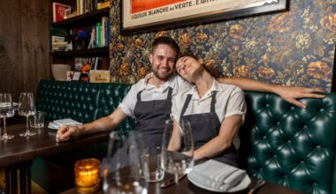 Chefs Alex Kemp and Amanda Shulman cuddling on a banquette at My Loup in 2023.