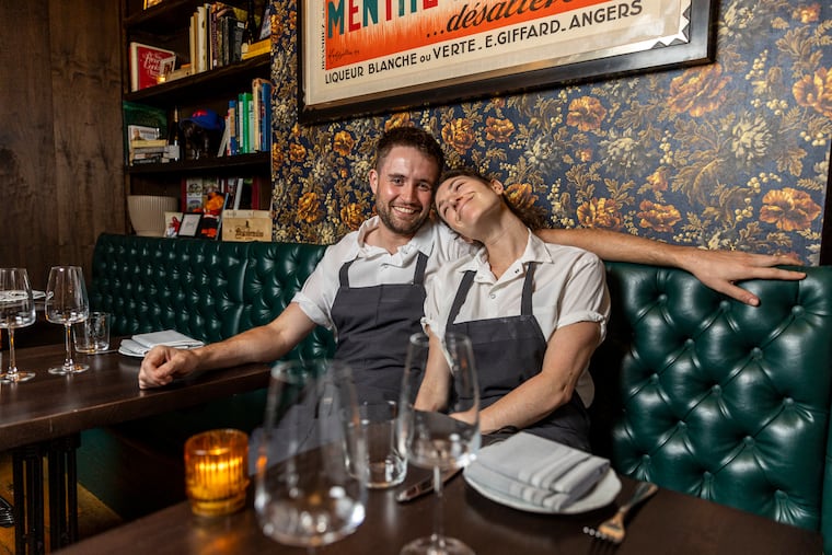 Chefs Alex Kemp and Amanda Shulman cuddling on a banquette at My Loup in 2023.