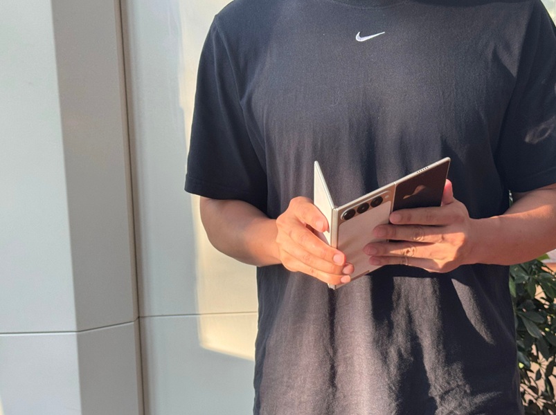 An alleged real life photo of a person unfolding TECNO's Ultimate G Fold concept foldable phone.