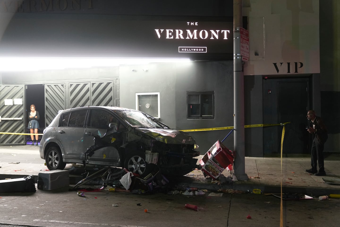 A vehicle sits on the sidewalk after ramming into a crowd of people waiting to enter a nightclub along a busy boulevard in Los Angeles, July 19, injuring several people.