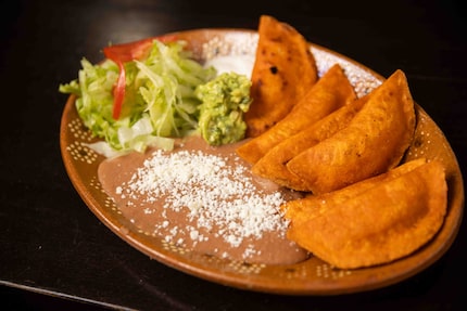 Enchiladas potosinas are served with a side of beans and salad at El Rincon Potosino in...