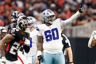 Dallas Cowboys offensive tackle Tyler Guyton (60) signals to the sideline during the second...