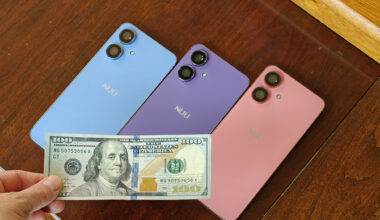 Three different Nuu N20 phones in blue, purple, and pink, with a $100 bill on front of them