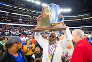 Duncanville head coach Reginald Samples lifts the championship trophy after a victory over...
