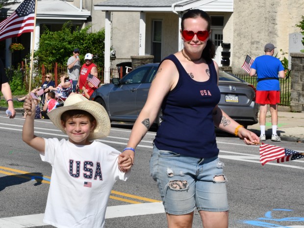 Joshua Ryan and mom Chelsea patriotically wave the stars and...