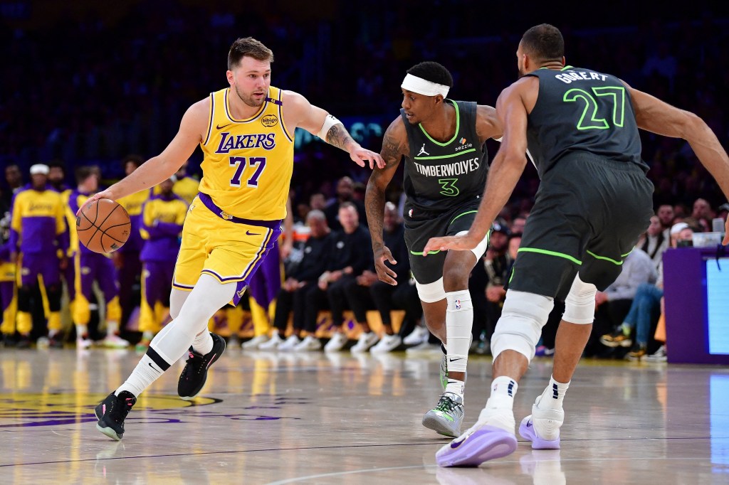  Los Angeles Lakers guard Luka Doncic (77) moves the ball against Minnesota Timberwolves forward Jaden McDaniels (3) and center Rudy Gobert (27) during the first half in game five of first round for the 2025 NBA Playoffs at Crypto.com Arena. 