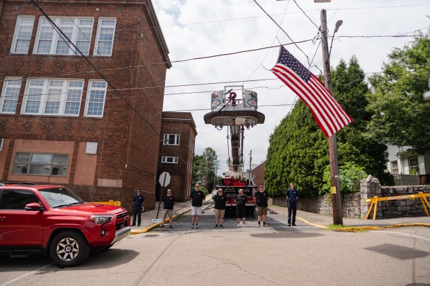 Firefighters stand in silence as the funeral procession for Thomas...