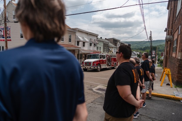 Firetrucks take part in a funeral procession for Thomas J....