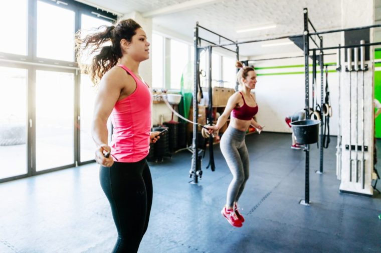 A small group of gym goers keeping fit and healthy by using skipping ropes together.