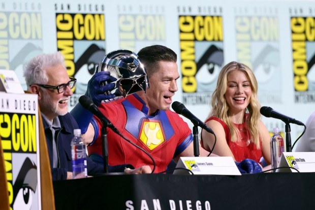 James Gunn, John Cena, and Jennifer Holland speak onstage at HBO Max "Peacemaker" panel. (Photo by Amy Sussman/Getty Images)