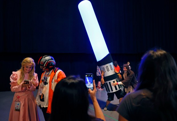 A fan dressed as a giant lightsaber at the Sneak Peek: Lucas Museum Of Narrative Art panel during Comic-Con International on July 27, 2025 in San Diego, California. (K.C. Alfred / The San Diego Union-Tribune)
