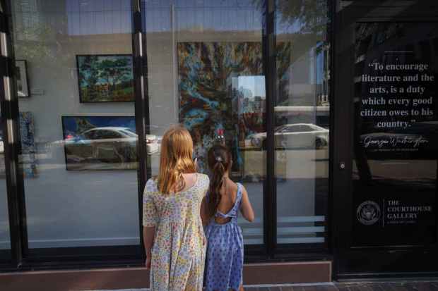 Two children admire paintings that are part of "The Art of Freedom," the inaugural exhibit of The Courthouse Gallery, a new public art project, on June 25 at the Edward J. Schwartz Courthouse in downtown San Diego. (Michael Ho / The San Diego Union-Tribune)