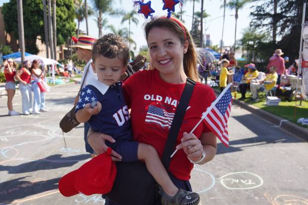 ....Irene Spinello brings her son to the parade with a flag of the United States on Friday, July 4, 2025 in Coronado, CA. (Michael Ho / The San Diego Union-Tribune)