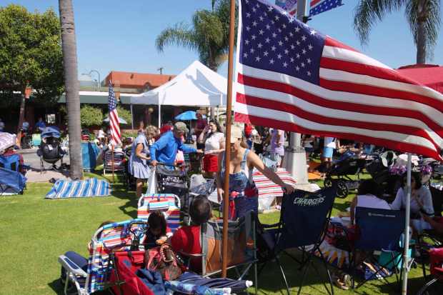 ....People set up their camps at Orange Ave before the parade begins on Friday, July 4, 2025 in Coronado, CA. (Michael Ho / The San Diego Union-Tribune)