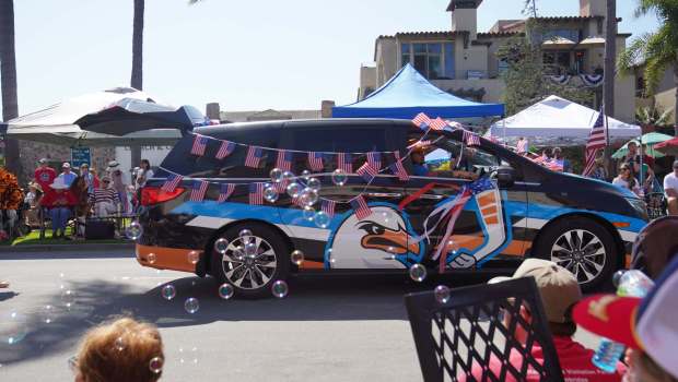 ....People from the San Diego Gulls Hockey Club drive their mini van at Orange Ave during the parade on Friday, July 4, 2025 in Coronado, CA. (Michael Ho / The San Diego Union-Tribune)
