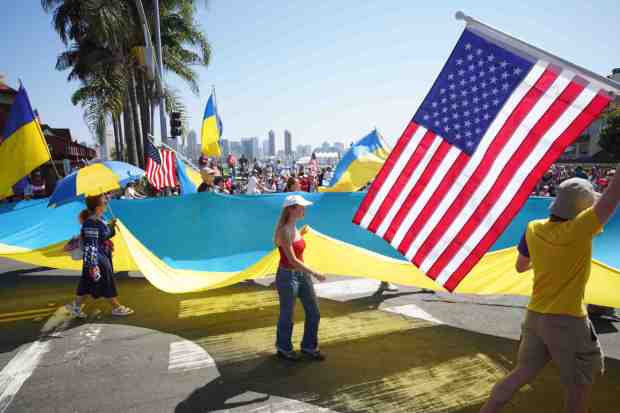 ....People from the House of Ukraine with Shield of Freedom hold the flags of Ukraine and the flags of the United States during the parade on Friday, July 4, 2025 in Coronado, CA. (Michael Ho / The San Diego Union-Tribune)
