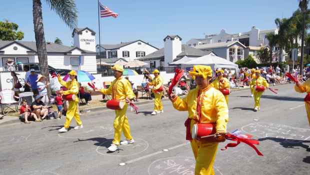 ....People from the Falun Dafa perform at Orange Ave during the parade on Friday, July 4, 2025 in Coronado, CA. (Michael Ho / The San Diego Union-Tribune)