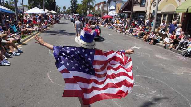 Sajwnee Bartoa walks down Orange Avenue in Coronado during the city's Independence Day parade Friday. The city followed the parade with concerts at Spreckels Park and fireworks over Glorietta Bay. Michael Ho / U-T