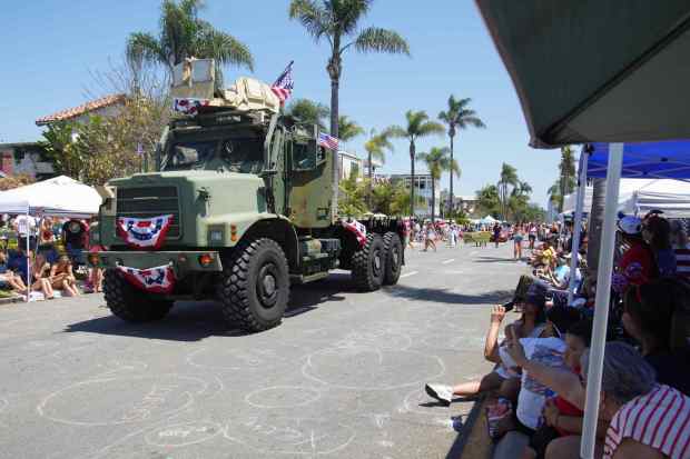 ....An officer from the U.S. Navy drive a truck at Orange Ave to participate the parade on Friday, July 4, 2025 in Coronado, CA. (Michael Ho / The San Diego Union-Tribune)