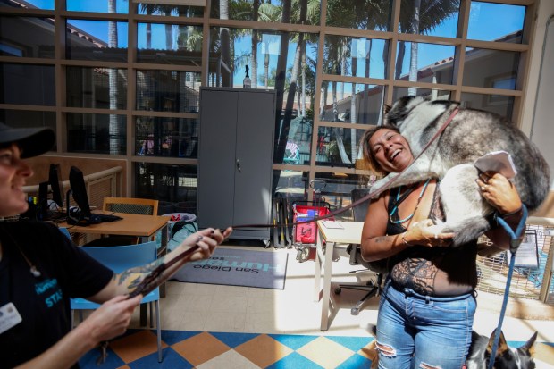 Leticia Leos shares a moment with her dog Storm after reuniting at the San Diego Humane Society on Sunday, July 6, 2025. Storm ran-off during a fireworks show along San Diego Bay on the Fourth of July. (Photo by Sandy Huffaker for The San Diego Union-Tribune)