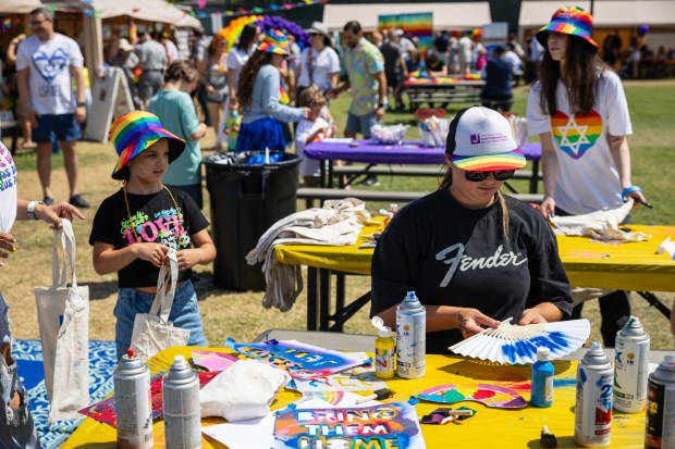 Attendees of The J Pride Festival use stencils to decorate fans and tote bags on Saturday, July 19, 2025 in San Diego, CA. (Zoë Meyers / For The San Diego Union-Tribune)