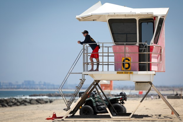 A lifeguard looks out at Imperial Beach on Wednesday, July 2, 2025 in Imperial Beach, CA. (Meg McLaughlin / The San Diego Union-Tribune)