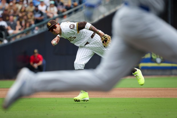 San Diego Padres' Manny Machado attempts to throw out Los Angeles Dodgers' Freddie Freeman during the sixth inning at Petco Park on Wednesday, June 11, 2025 in San Diego, CA. (Meg McLaughlin / The San Diego Union-Tribune)