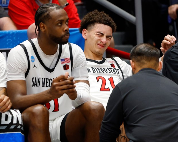 SDSU's Miles Byrd is treated by athletic trainer Sergio Ibarra during the NCAA Tournament game against North Carolina last March. (K.C. Alfred / The San Diego Union-Tribune)