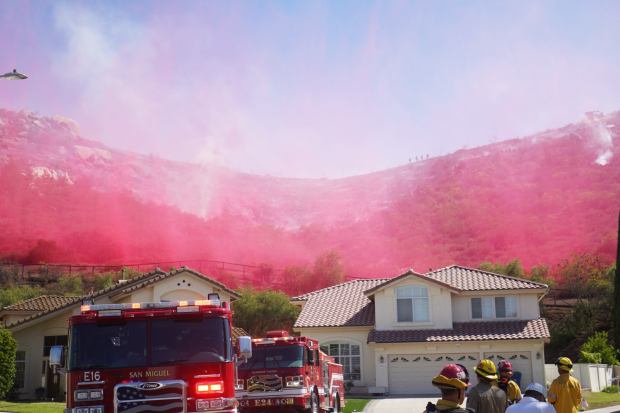 ....Fire helicopters drop fire retardant near Steele Canyon Rd to battle the wildfire on Wednesday, July 9, 2025 in Jamul, CA. (Michael Ho / The San Diego Union-Tribune)