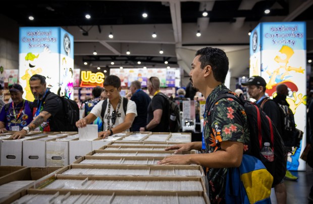 Richard Guevara, a collector from San Diego, searches for a classic Avengers comic at San Diego Comic-Con on Thursday, July 24, 2025 in San Diego, California. (Ana Ramirez / The San Diego Union-Tribune)