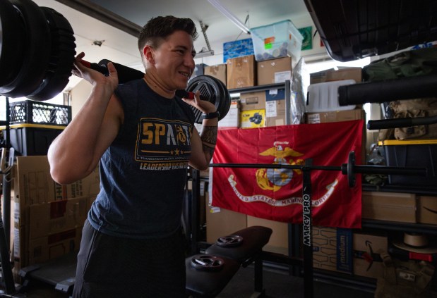 Marine Capt. Sye Savoie works out in their home gym on Tuesday, June 24, 2025 in Oceanside, California. (Ana Ramirez / The San Diego Union-Tribune)