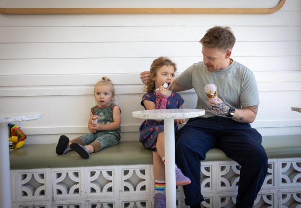 Sam Rodriguez, a lieutenant junior grade and medical corps officer for the U.S. Navy, enjoys ice cream with their children at Stella Jean's on Wednesday, July 2, 2025, in San Diego. (Ana Ramirez / The San Diego Union-Tribune)