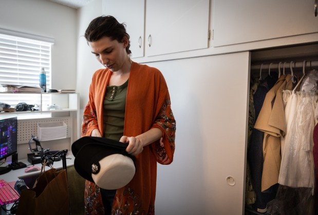 U.S. Navy Petty Officer Second Class Saddie Kolterman pulls out a bucket cover on Thursday, July 3, 2025 in Coronado. (Ana Ramirez / The San Diego Union-Tribune)