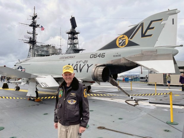 On the deck of the USS Midway, Vern Jumper stands in front of the type of F-4 Phantom aircraft that he flew in the Navy. (Jumper family)