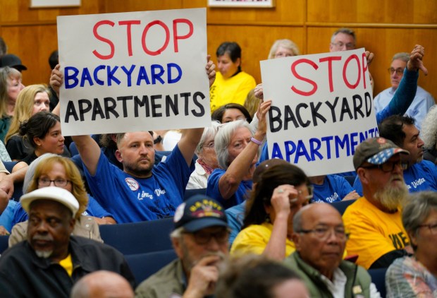 Kyle Candee of Linda Vista, holding sign, left, and others urged council members to roll back San Diego's ADU incentive before a committee's vote on it Thursday, May 15, 2025. (Howard Lipin / For The San Diego Union-Tribune)