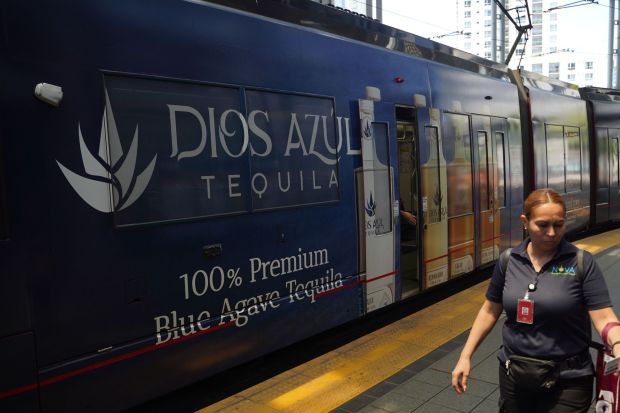 A train with a Dios Azul Tequila advertisement stops at America Plaza on Monday, July 7, 2025 in San Diego. (Michael Ho / The San Diego Union-Tribune)