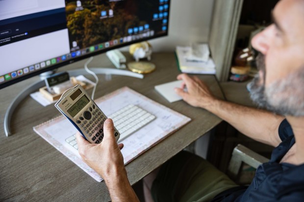 Steve Nowak calculates the tax charged by Amazon on a recent purchase on Thursday, July 24, 2025 in Vista, CA. He has been charged a higher tax than he should be on purchases from the company. (Zoë Meyers / For The San Diego Union-Tribune)