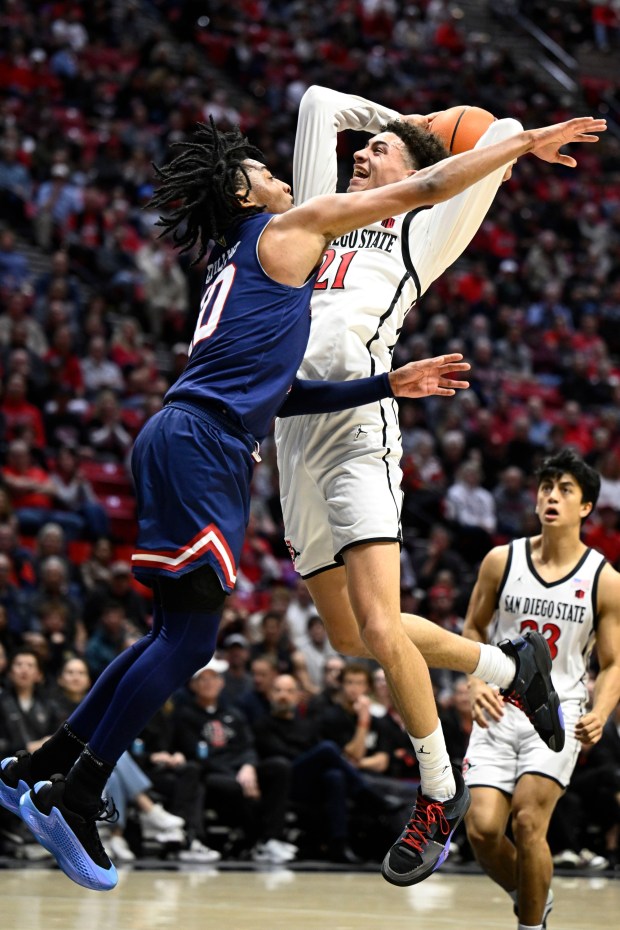 San Diego State guard Miles Byrd (21) shoots over Fresno State guard Zaon Collins (10), Feb., 18, 2025 in San Diego, Calif. (Photo by Denis Poroy)
