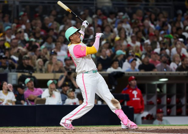 Manny Machado #13 of the San Diego Padres hits a home run against the Philadelphia Phillies during the eighth inning at Petco Park on Friday, July 11, 2025 in San Diego, CA. (Meg McLaughlin / The San Diego Union-Tribune)