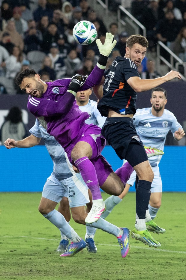 San Diego Football Club's Christopher McVey (97) and Sporting KC's goalkeeper, John Pulskamp (1) battle for the cross during Saturday's Major League Soccer match against Sporting Kansas City at Snapdragon Stadium in San Diego, CA. (Xavier Hernandez for the UT)