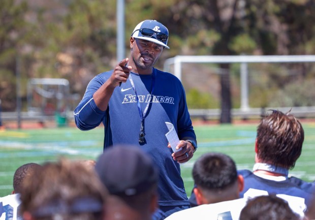 USD coach Brandon Moore speaks to the team at the end of the practice last year. (Charlie Neuman / For The San Diego Union-Tribune)