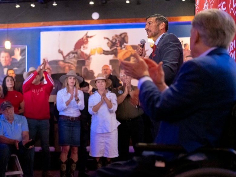 Marc LaHood, a candidate for Texas House of Representatives (R-121) appeals to voters along with Governor Greg Abbott at the Angry Elephant on Wednesday.