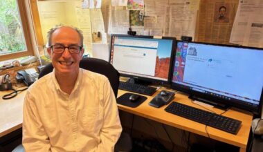 Dr. Scott Schiff-Slater sits at his desk in Hallowell, Maine. (Patty Wight/Maine Public)