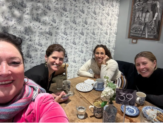 Four members of Science Moms pose for a selfie at the annual meeting of the American Geophysical Union, December 2024. From left to right: Joellen Russell, Erica Smithwick, Claudia Benetiz-Nelson, and Emily Fischer. 