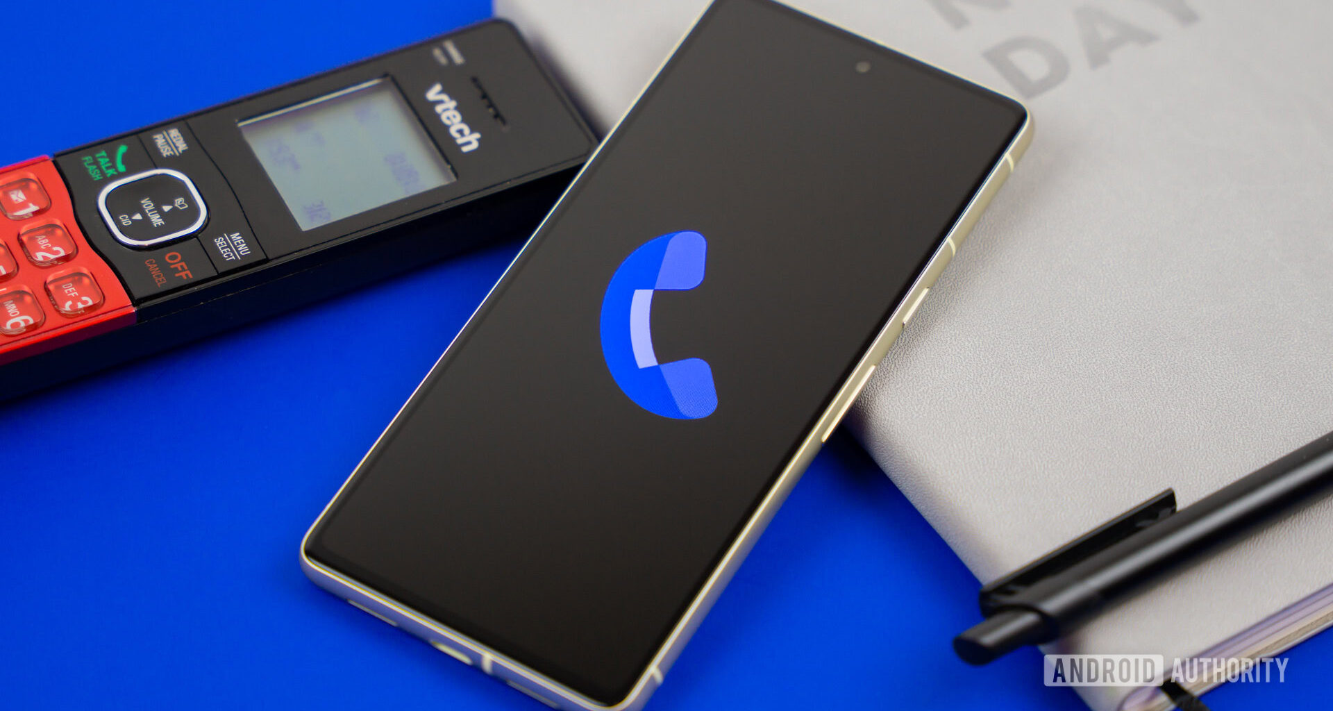 Stock photo of Phone by Google app on phone next to home phone agenda and pen 5